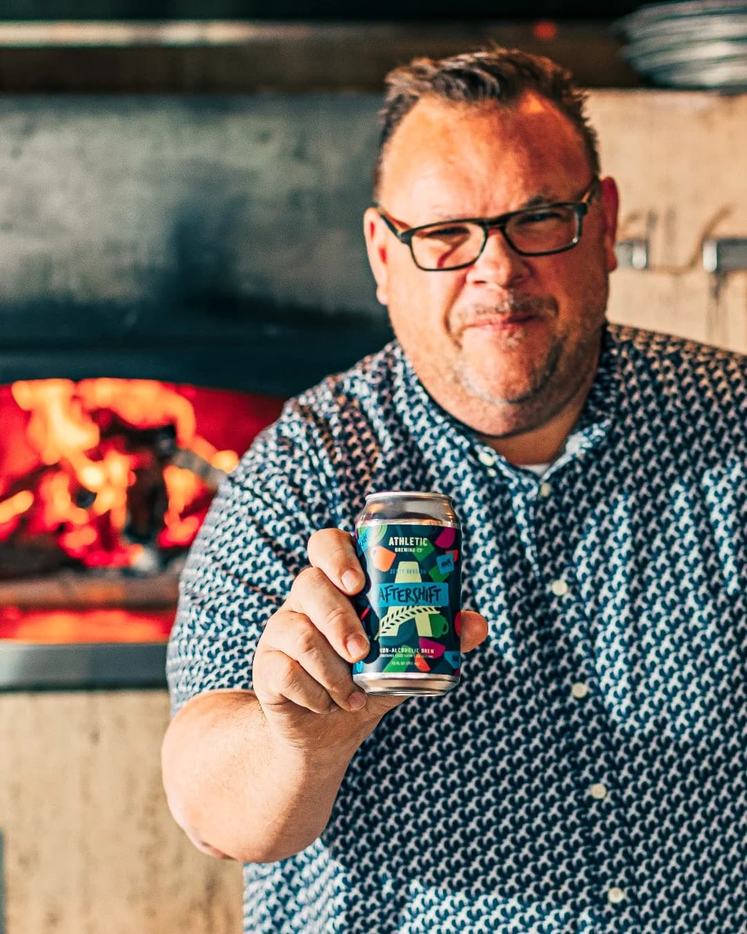 Athletic Brewing Aftershift — Lifestyle Product Hold