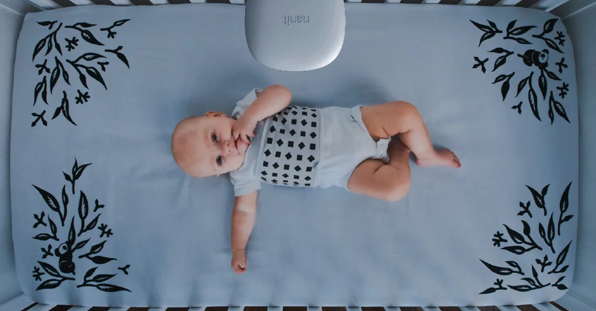 Nanit family ad example workhorse crib shot running with zero overlaid copy