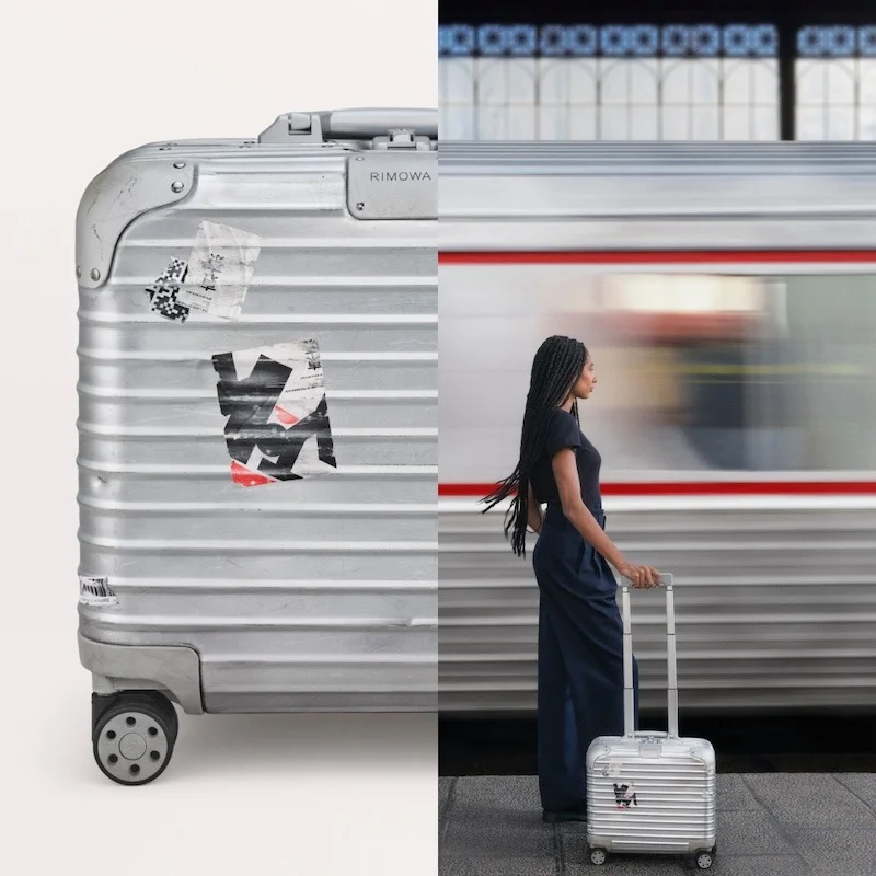 Rimowa luxury ad example: aluminum case macro beside a model on a train platform, silver train blurred behind