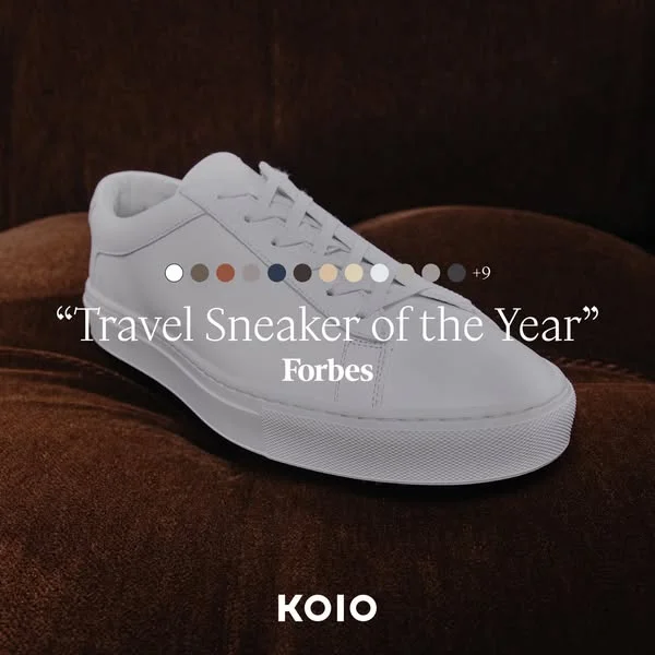 Koio luxury ad example: a white leather sneaker over a brown velvet sofa with a Forbes quote in italic serif